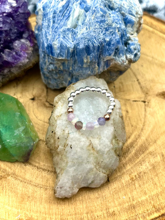 Pink Tournaline, Kunzite and Opal. Sterling silver stretch ring with solid rose gold accents.