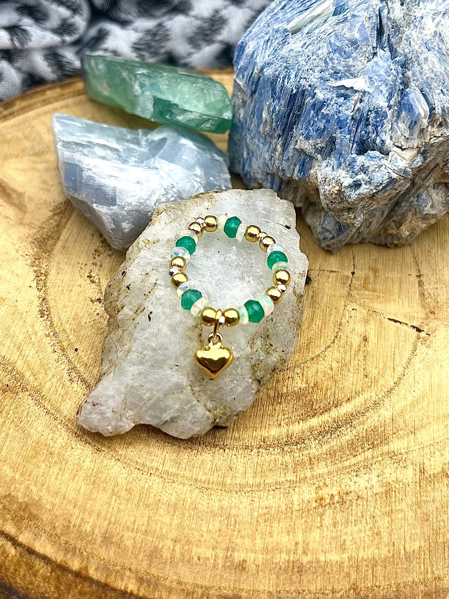 Green onyx and Opal with gold plated silver beads and heart and sterling silver. Stretchy Ring available in small, medium and large.