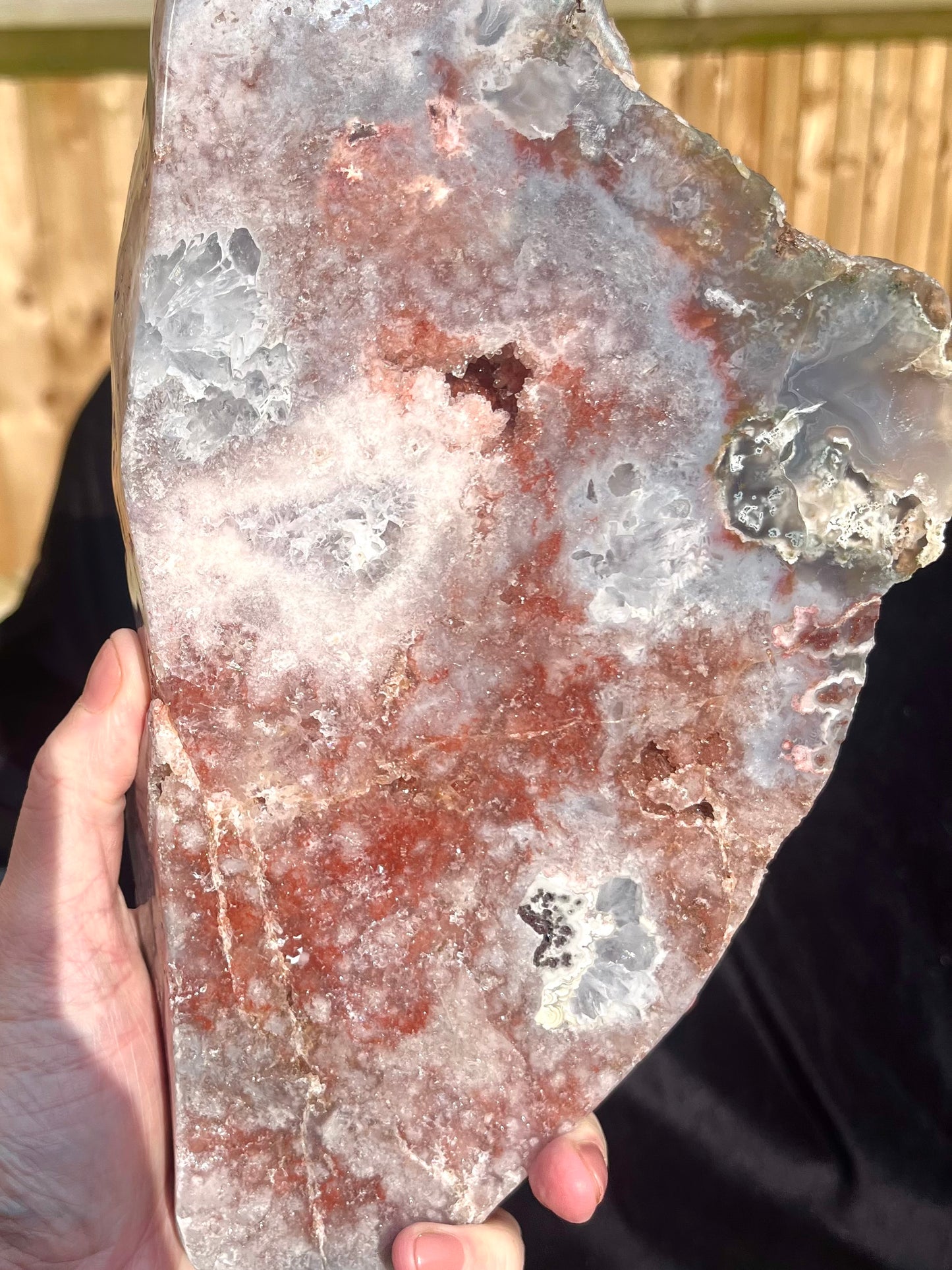 Stunning polished slice with pink amethyst, clear quartz and agate on stand.