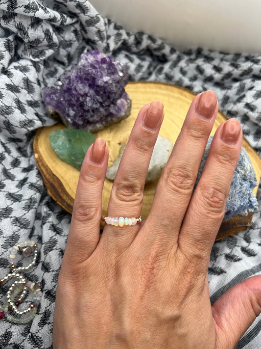 Kunzite and Opal. Sterling silver stretch ring with solid rose gold accents.