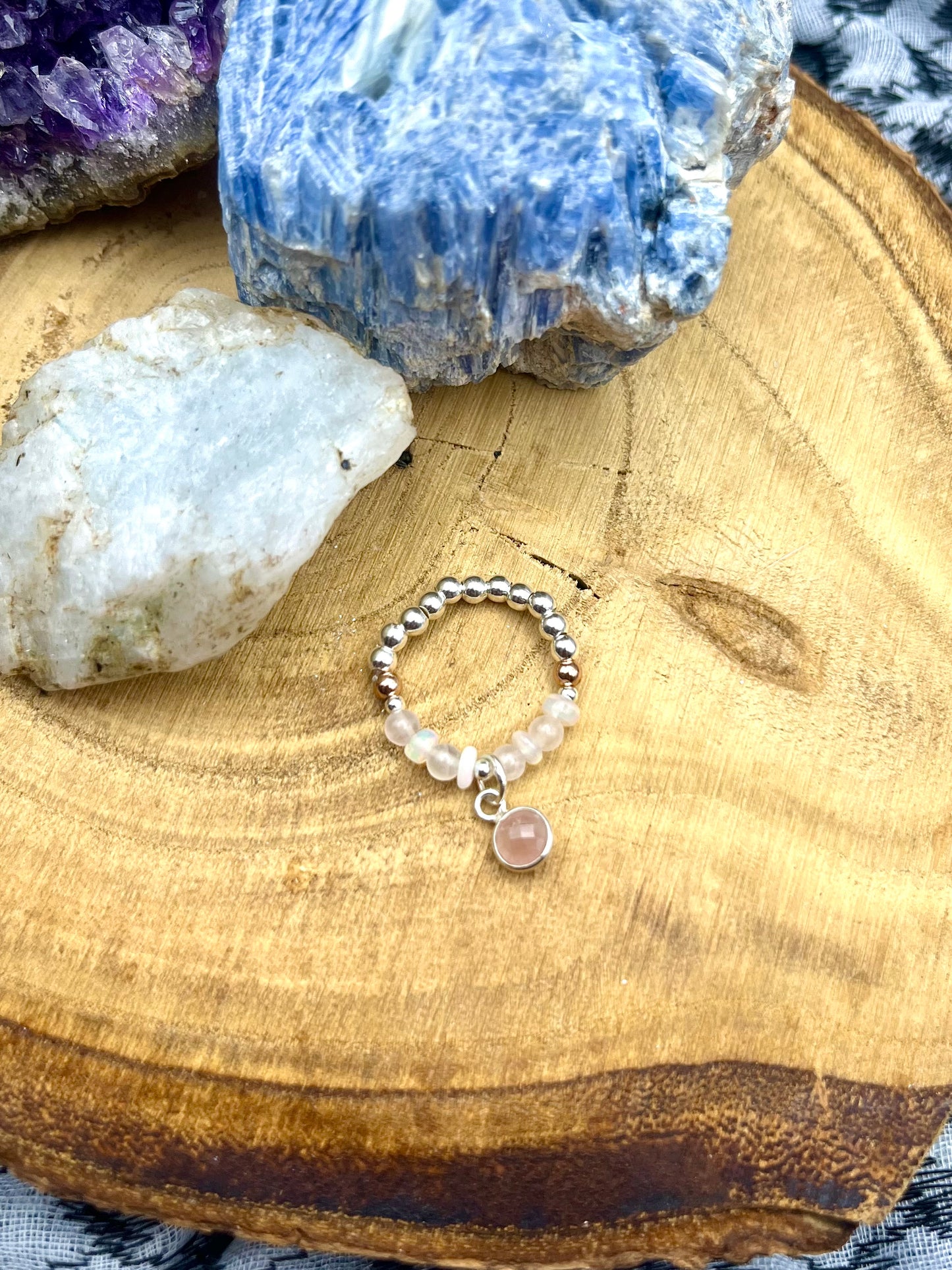 Opal and Rose Quartz with rose quartz charm. Sterling silver stretch ring with solid rose gold accents.
