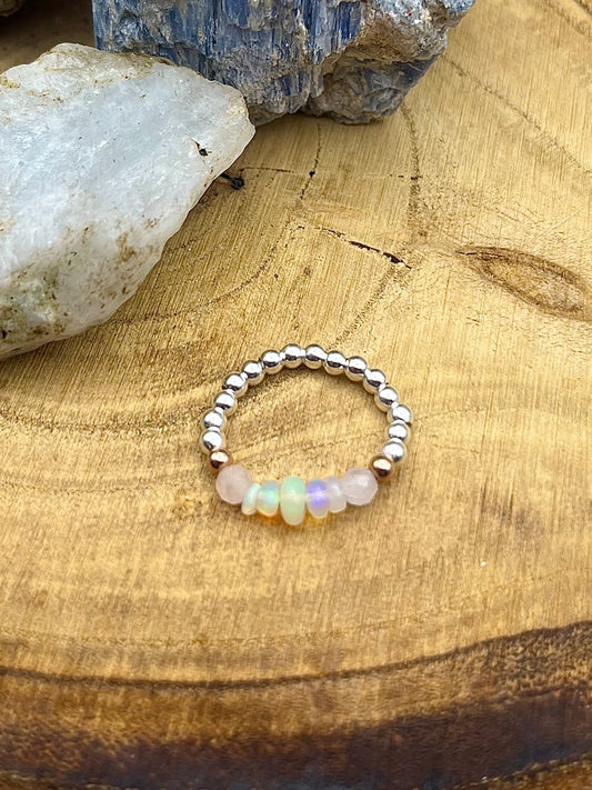 Kunzite and Opal. Sterling silver stretch ring with solid rose gold accents.