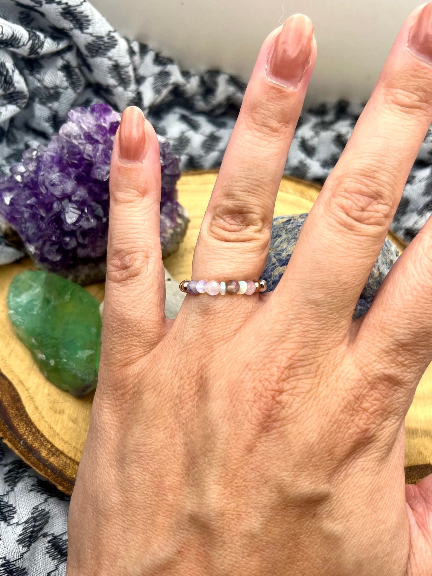 Pink Tournaline, Kunzite and Opal. Sterling silver stretch ring with solid rose gold accents.