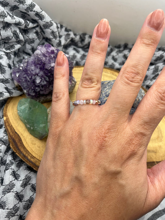 Pink Tournaline, Kunzite and Opal. Sterling silver stretch ring with solid rose gold accents.