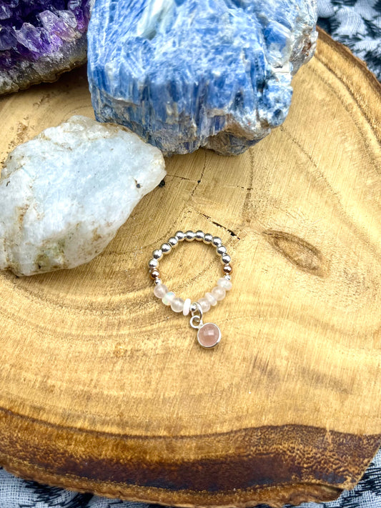 Opal and Rose Quartz with rose quartz charm. Sterling silver stretch ring with solid rose gold accents.