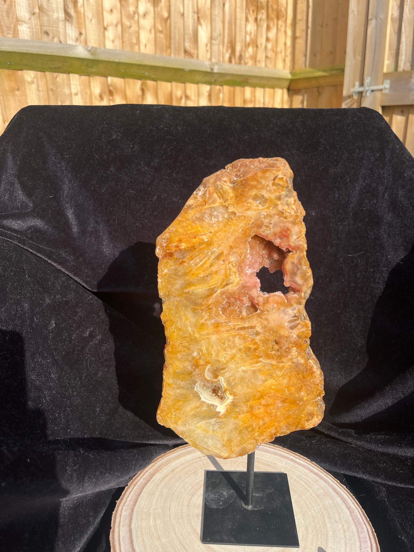 Stunning Golden Healer polished slice with pink amethyst and agate on stand.