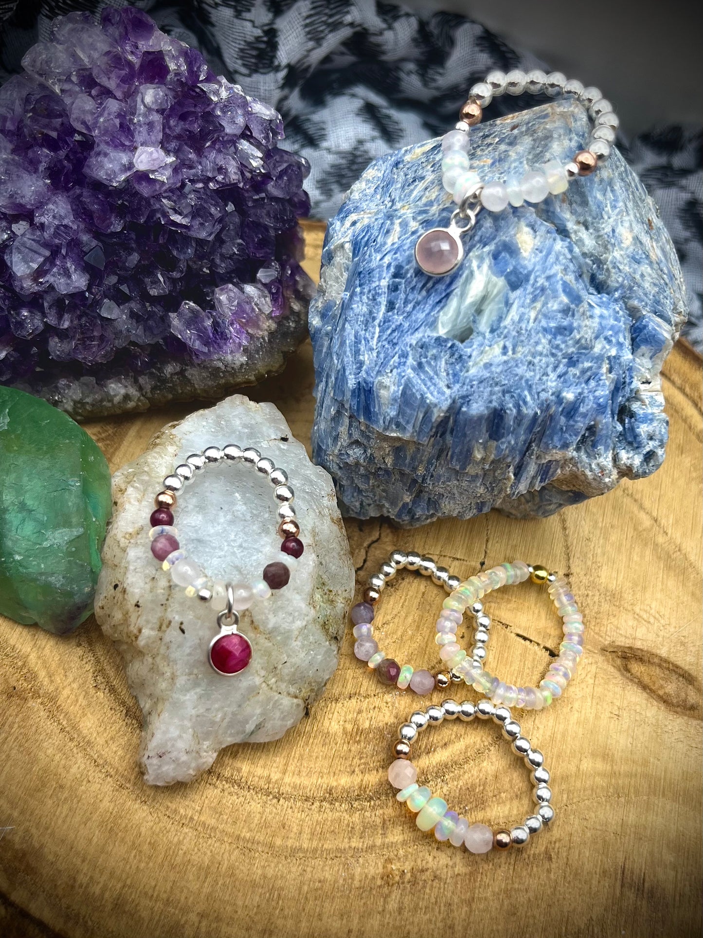 Opal and Rose Quartz with rose quartz charm. Sterling silver stretch ring with solid rose gold accents.
