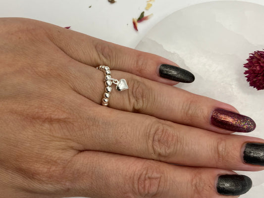 Sterling silver heart charm and stretch ring.