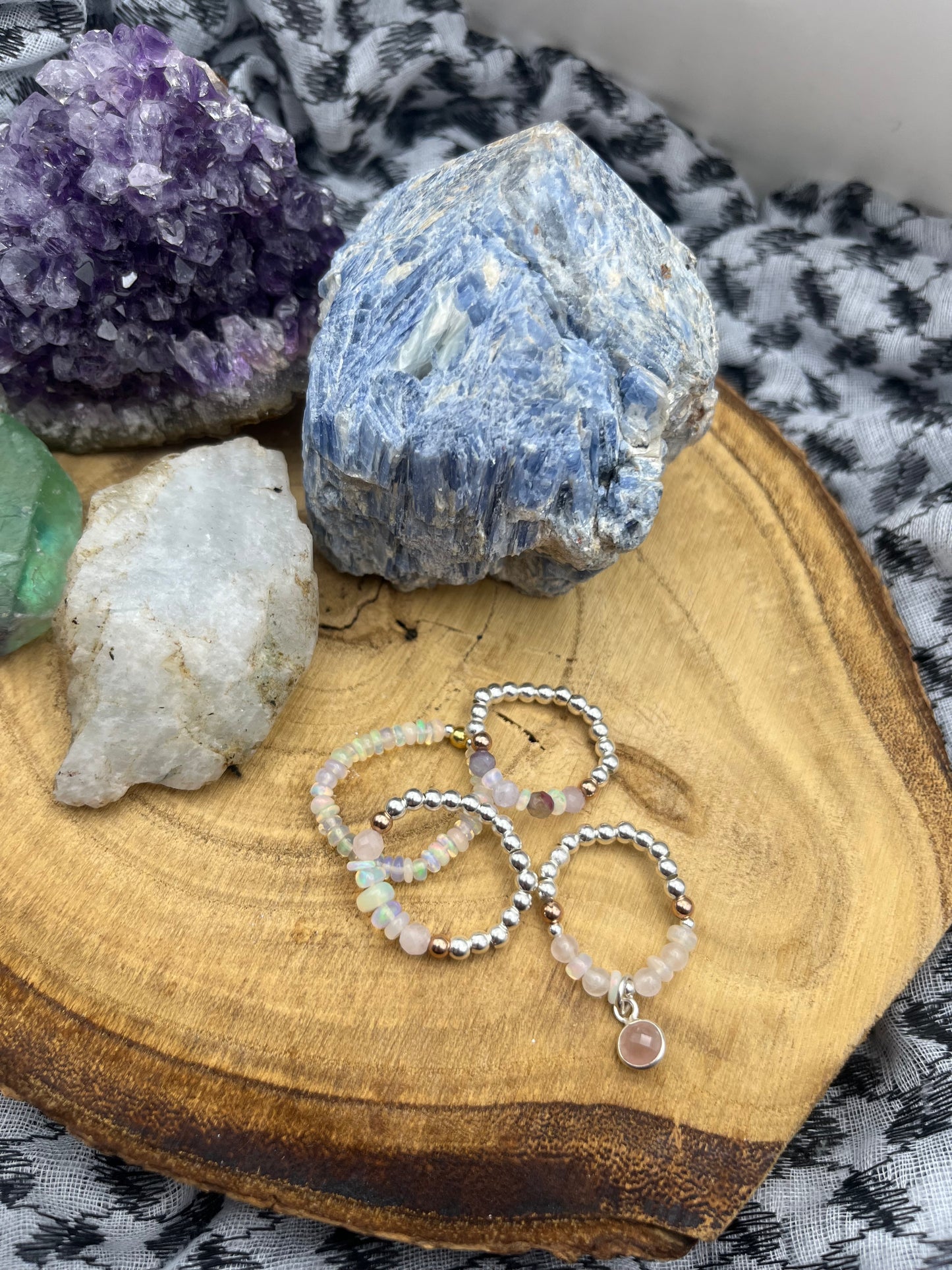 Kunzite and Opal. Sterling silver stretch ring with solid rose gold accents.