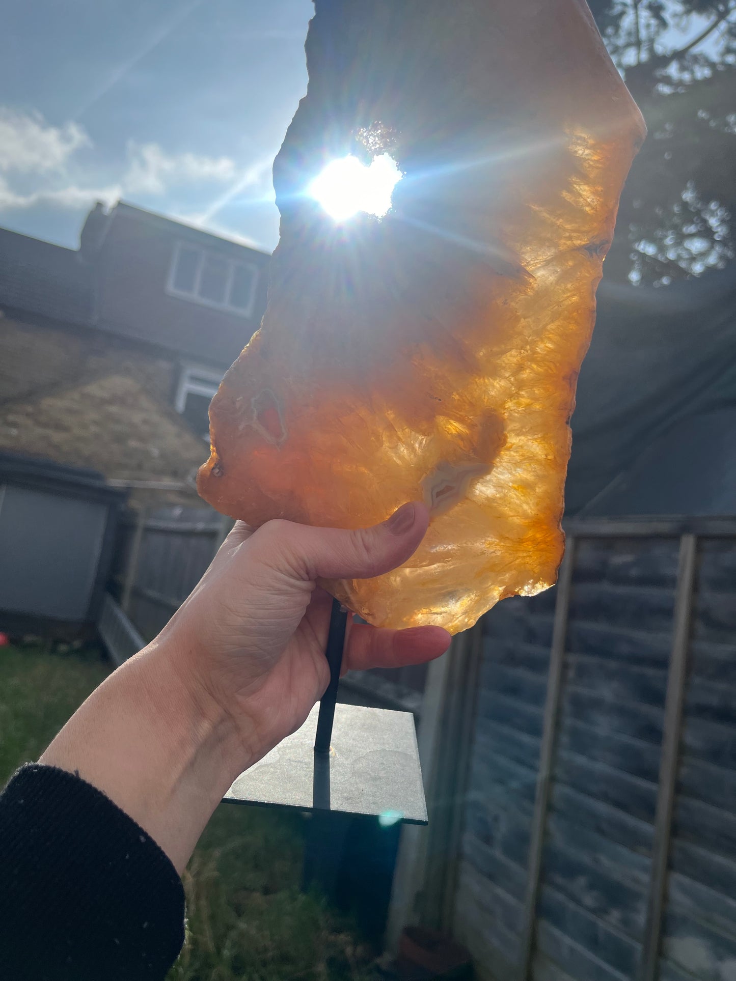Stunning Golden Healer polished slice with pink amethyst and agate on stand.