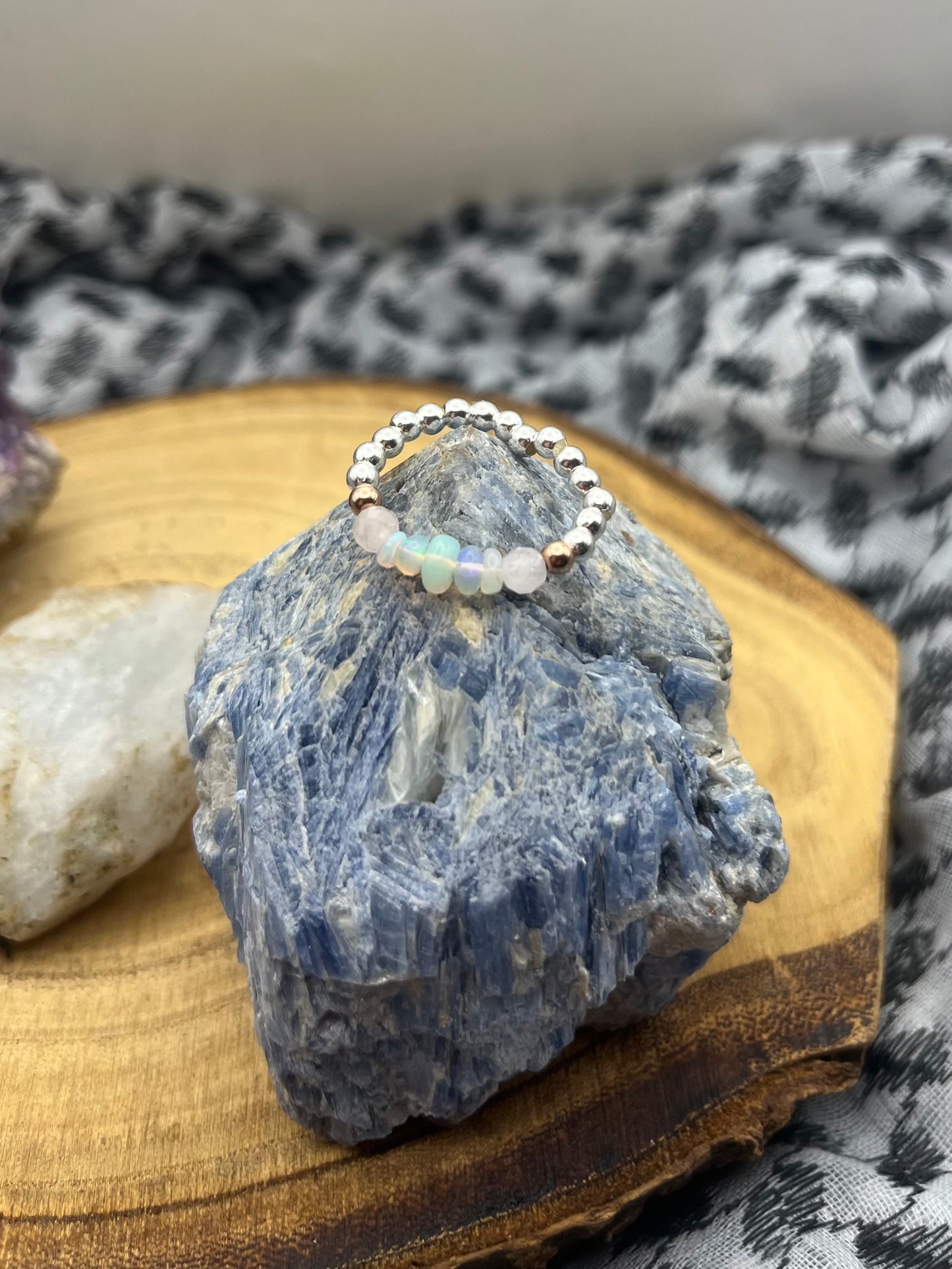 Kunzite and Opal. Sterling silver stretch ring with solid rose gold accents.