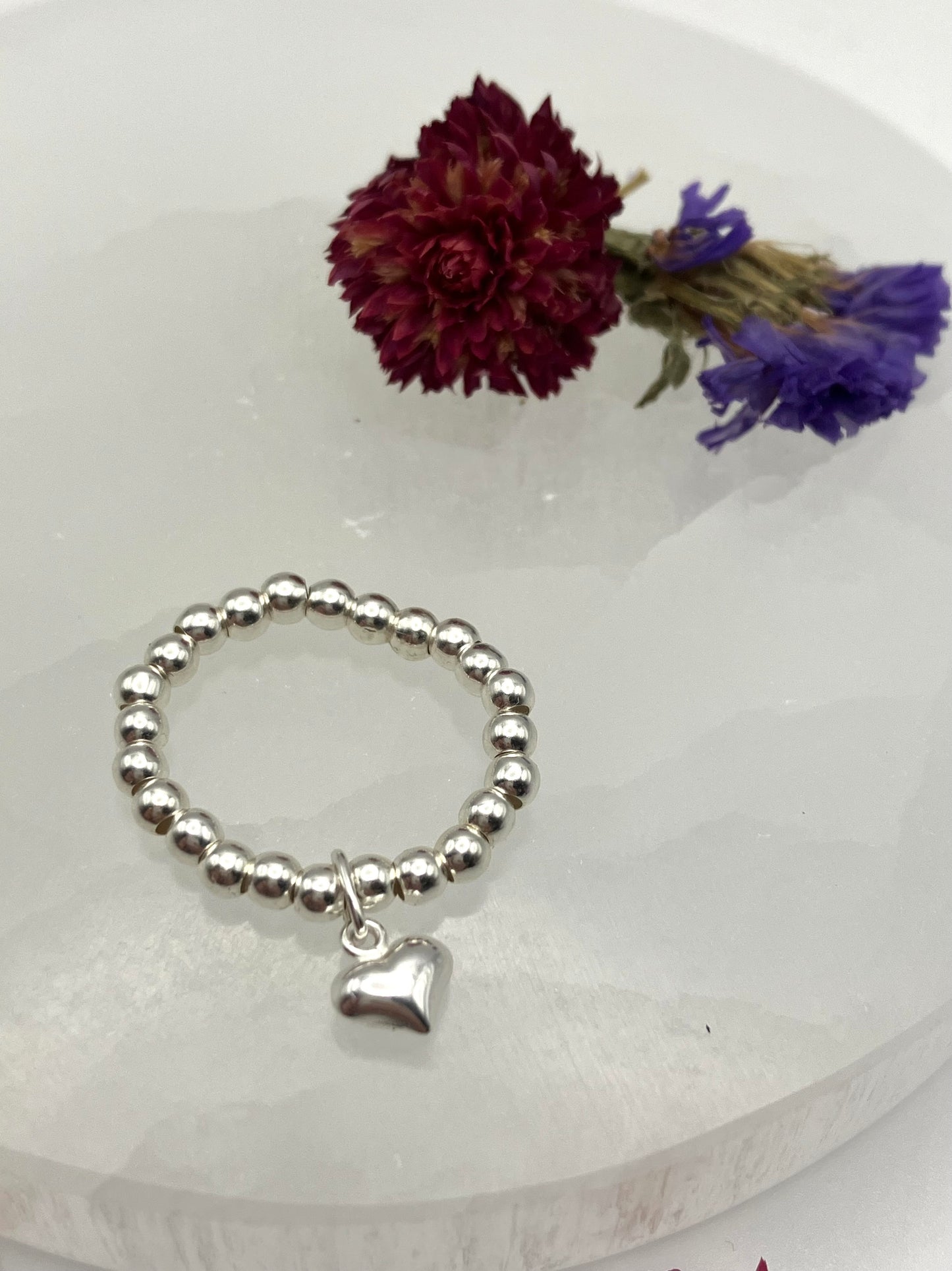 Sterling silver heart charm and stretch ring.
