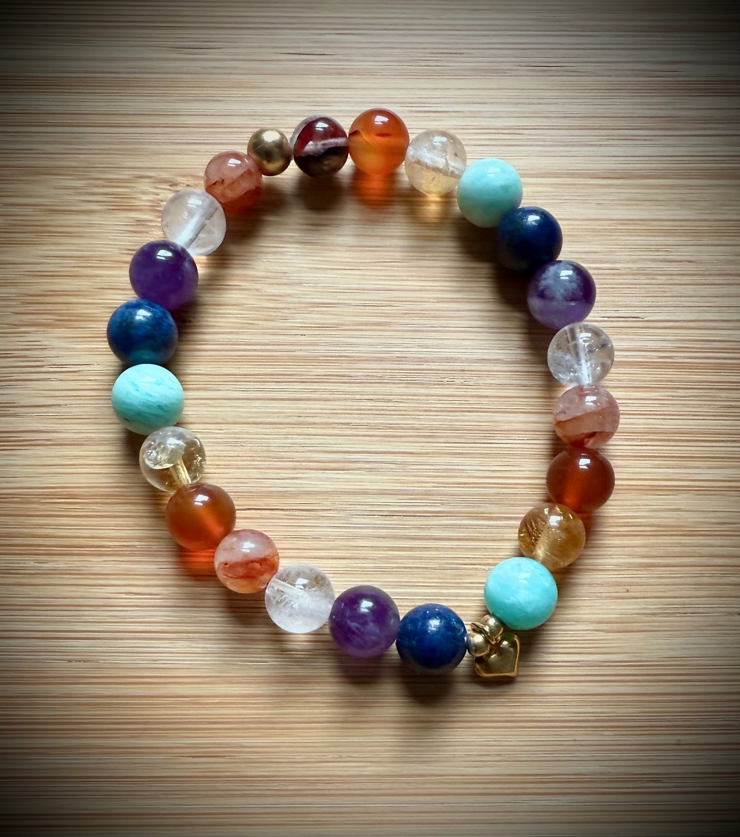 Handmade 7 Chakra stretch bracelet. 8mm Premium Crystal beads with sterling silver.