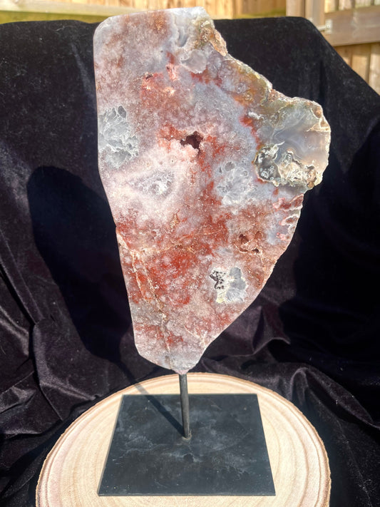 Stunning polished slice with pink amethyst, clear quartz and agate on stand.