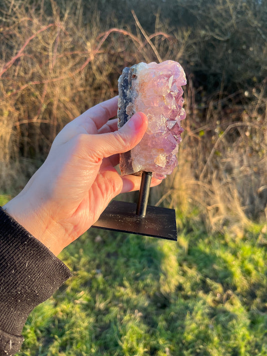 A grade Amethyst cluster on stand (attached). 730g.