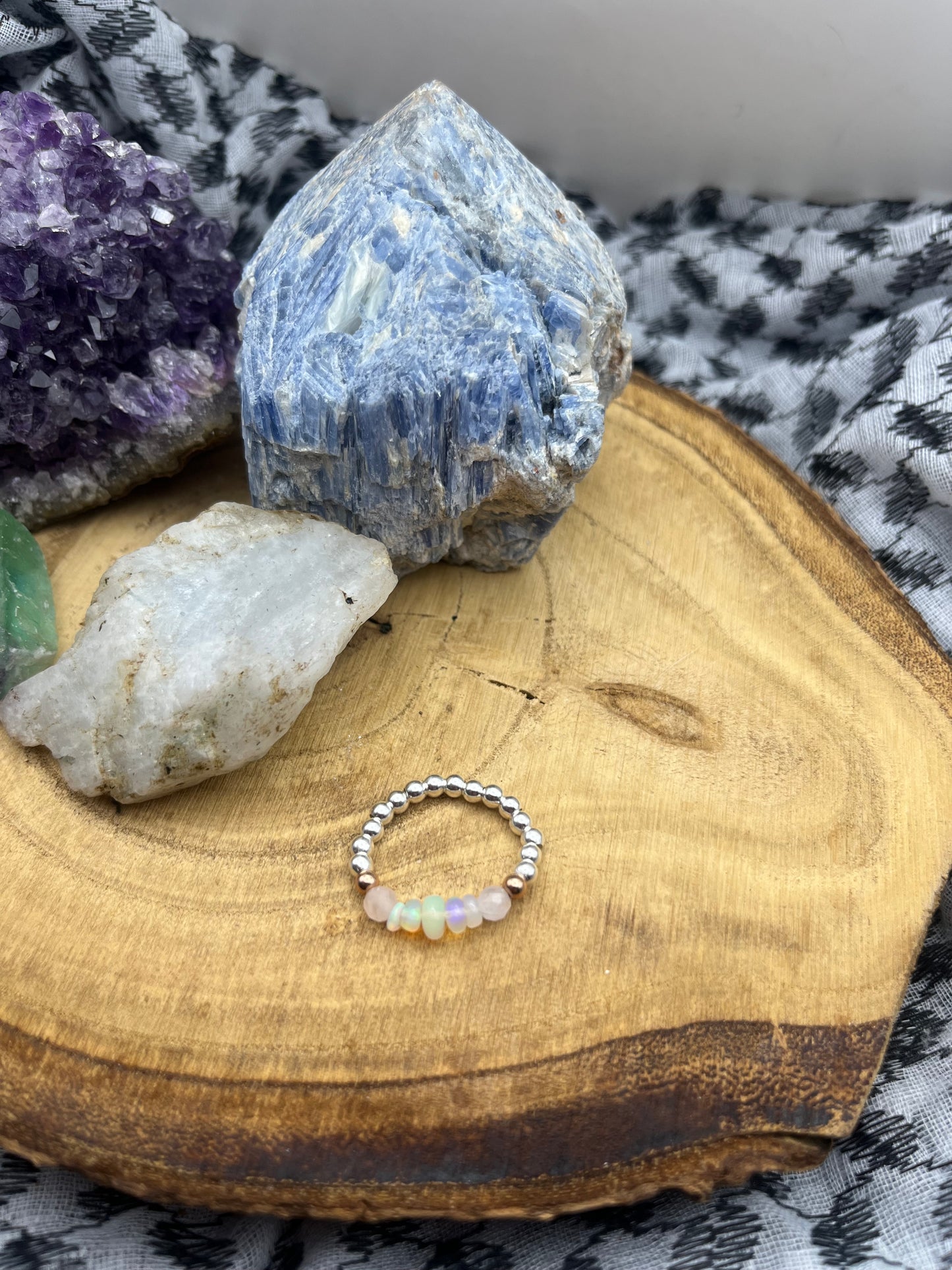 Kunzite and Opal. Sterling silver stretch ring with solid rose gold accents.