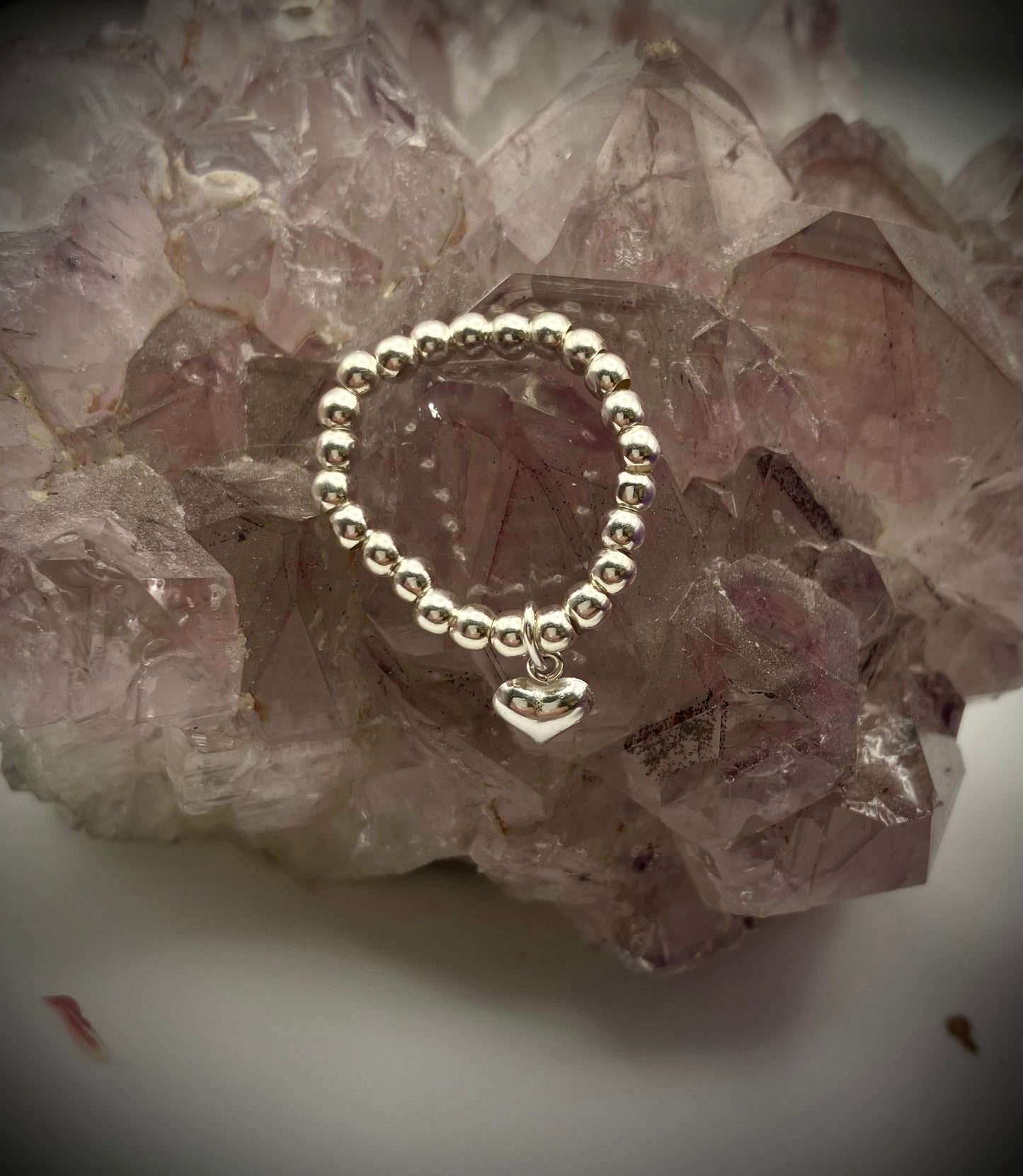 Sterling silver heart charm and stretch ring.